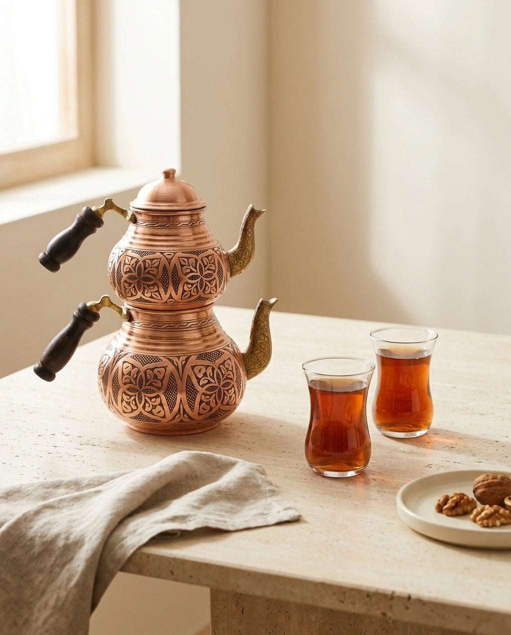 İki bardak çay ve ceviz tabağı ile mermer masada sunulan el işlemesi bakır çaydanlık. - Gaziantep Bakırcılık